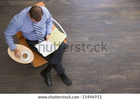 Stockfoto: Studying Document In Office Lobby