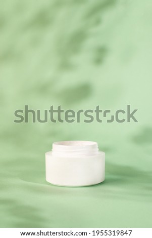 Stok fotoğraf: Face Cream Moisturizer Jar On Mint Background Moisturizing Skin