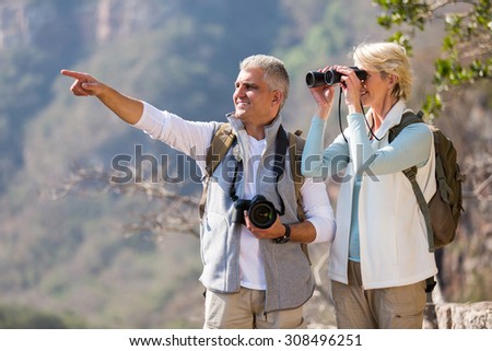 Foto stock: Beautiful Tourist Hiking And Using Binoculars