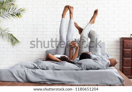 Foto stock: Young Adult Couple Lying On Bed