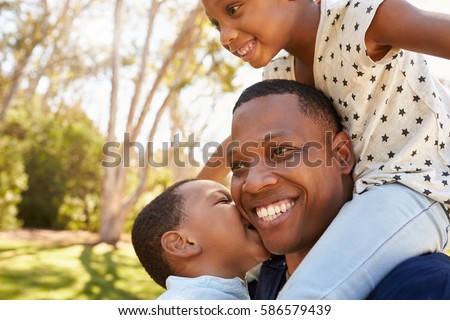 Stok fotoğraf: Portrait Of Happy African American Father And Daughter Kissing Mother On Cheeks At Home