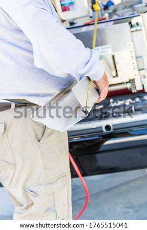 Zdjęcia stock: Worker Measuring Rain Gutter Processing Through Seamless Shaping