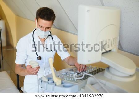 Stock photo: Portrait Of Young Male Technician Operating Ultrasound Machine