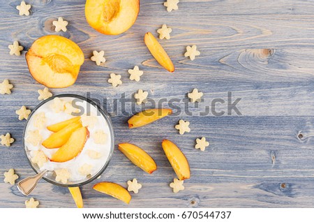 Stock fotó: Colorful Cheerful Smoothie With Yogurt Stars Corn Flakes Ripe Slice Peach On Blue Wood Board Top V