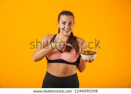 Foto stock: Image Of Overweight Woman 20s In Tracksuit Holding Plate With Gr