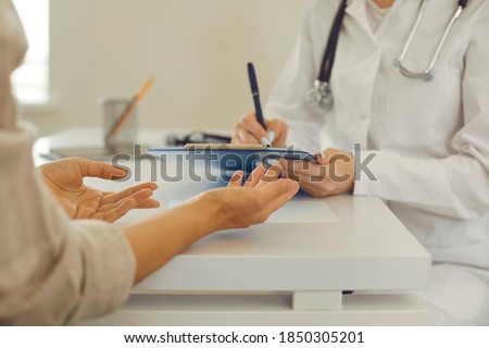 Foto stock: Crop Doctor Writing Down Complaints Of Patient