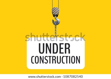 Stock photo: Under Construction Text Hanging Of A Hook Against Yellow Background