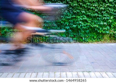 Stock photo: Motion Blurred Cyclists To Show Speed Driving Along A Bike Lane