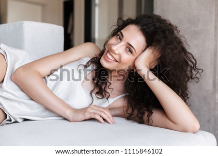 Foto stock: Closeup Of Woman Resting Her Head In Her Hands While Lying On Bed