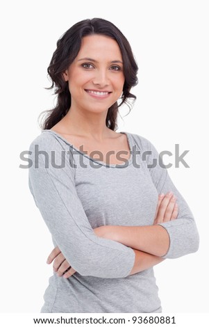 Stockfoto: Close Up Of Smiling Woman With Her Arms Folded Against A White Background