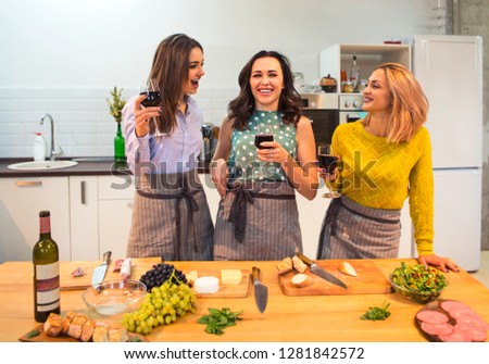 Сток-фото: Female Friends Preparing A Meal Together And Drinking Red Wine I