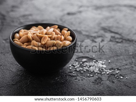 Stok fotoğraf: Salted And Roasted Peanuts Classic Snack In Black Bowl On Wooden Background
