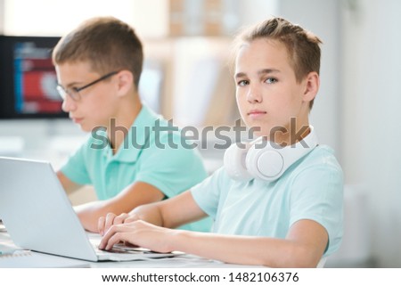 ストックフォト: Cute And Clever Schoolboy With Headpones On Neck Working Over Homework