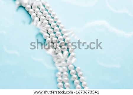 Stockfoto: Coastal Jewellery Fashion Pearl Necklace Under Blue Water Backg