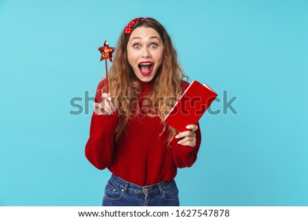 Stock photo: Image Of Delighted Woman Holding Notebook And Magic Wand While Screaming