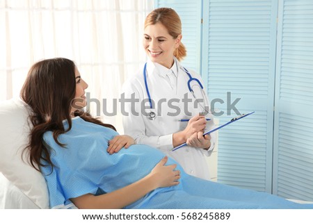 Stock photo: Doctor Fills Out Medical Record