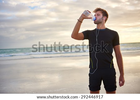 Сток-фото: Sports Bottle Drink Sport Man Drinking Water On Beach Run Male Runner Sweaty And Thirsty After Diff