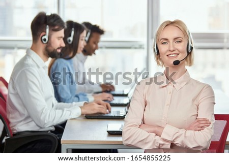 Stock fotó: Happy Operator Posing With A Headset Against A White Background