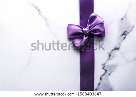 Stok fotoğraf: Purple Silk Ribbon And Bow On Luxury Marble Background Holiday