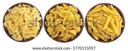 Stok fotoğraf: Raw Pasta Farfalle In Bowl With Copy Space On Wooden Background
