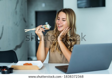 Stock foto: Woman On Laptop Eating Sushi