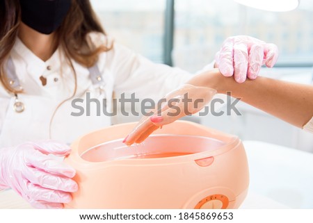 Stock photo: Manicurist Washing Customers Hand