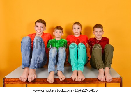 Stok fotoğraf: A Teenage Girl In White Clothes Is Squatting On A Yellow Background