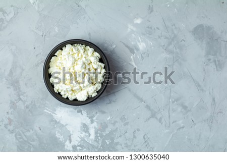 Stock photo: Homemade Cottage Cheese In A Black Ceramic Bowl On Light Gray Co