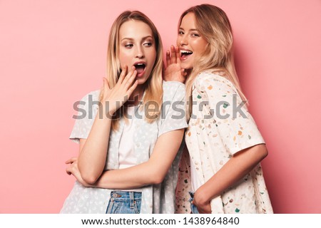 Foto stock: Excited Emotional Young Women Friends Posing Isolated Over Yellow Background Holding Books