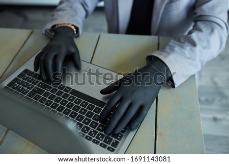 Stock fotó: Man Working From Home At Notebook Wearing Black Disposable Gloves For Protection