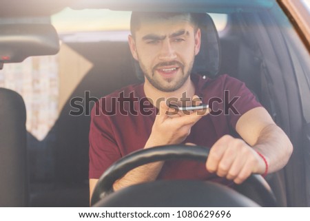 Stockfoto: Busy Businessman Drives Car Has Phone Call And Checks Information In Laptop Computer Wears Disposa