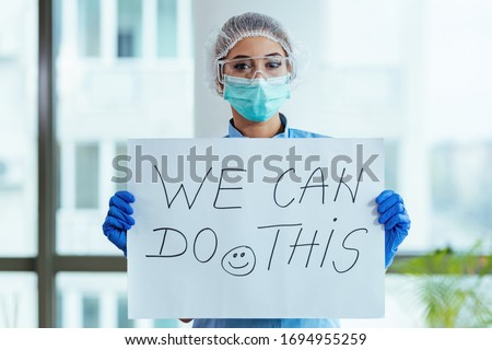 Foto stock: Covid 19 Coronavirus Doctor Holding Sign For Viral Social Media Post Showing We Stay At Work For Yo