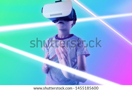 Сток-фото: Boy Using Virtual Reality Headset While Gesturing Against Light Trails On City Street