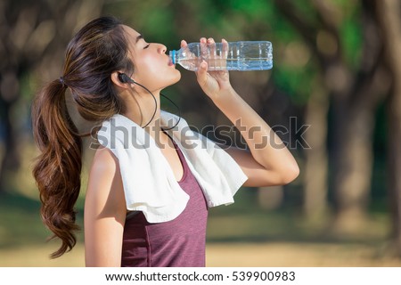 Stockfoto: Attractive Sporty Woman Drinking Water From A Bottle After Jogging Or Running