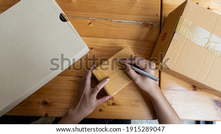 Сток-фото: Woman Writing Shipping Address