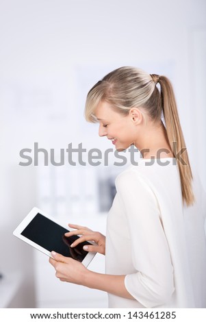 Stock photo: Side View Of Young Caucasian Businesswoman Standing Near Desk In Modern Office