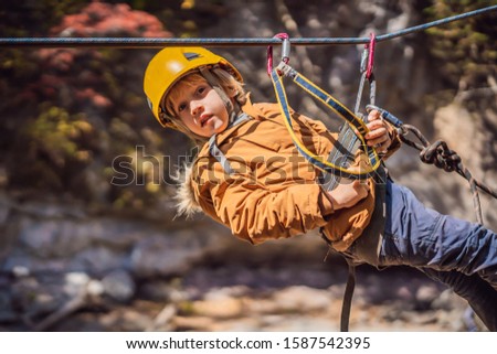 Stock fotó: Brave Little Boy Rappelling High Among The Trees In An Adventure Park For Children Extreme Kid The