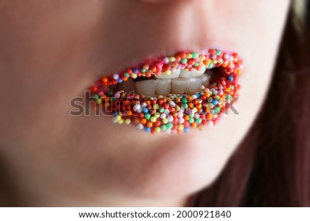 Stock photo: Beautiful Womans Mouth Full Of Colorful Sugar Pearls