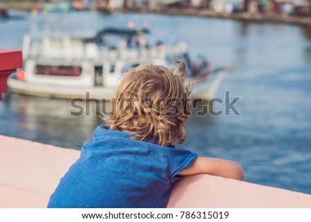 Stock fotó: The Boy Admires The Sea And Colourful Boats Moored At Phu Quoc Vietnam Boats Such As These Are Icon