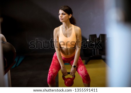 Сток-фото: Young Woman Doing Arm Exercise With Kettler Dumbbell All In Fron