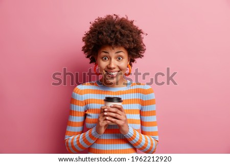 Stock fotó: Horizontal Shot Of Pleased Happy Woman Holds Both Hands Under Chin Has Smile On Face Dressed In De