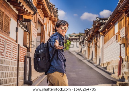 Stok fotoğraf: Young Man Tourist In Bukchon Hanok Village Is One Of The Famous Place For Korean Traditional Houses