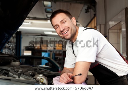 Сток-фото: Handsome Mechanic Based On Car In Auto Repair Shop With Tablet On Hand