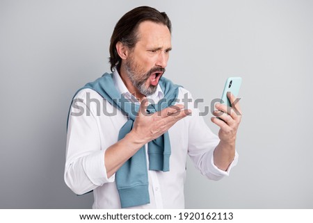 Сток-фото: Angry Mature Businessman Looking At Smartphone