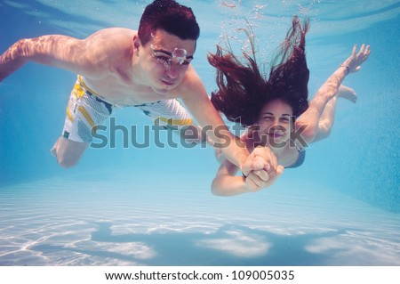 Zdjęcia stock: Happy Young Man And Woman Swimming Underwater In The Tropical Ocean