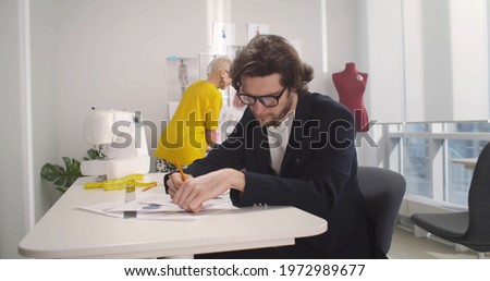 Stock fotó: Two Young Dressmaker Or Designer Colleagues Working And Discussi