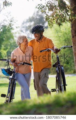 Stock fotó: Side View Of Active Senior Man With Senior Woman Riding Bicycle On The Beach