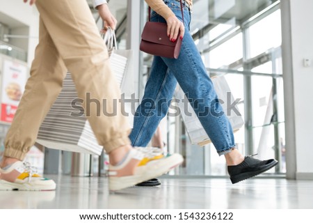 Stock fotó: Young Woman And Her Daughter In Jeans Carrying Paperbags While Leaving Mall