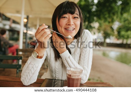 Stock photo: Woman Drinking Latte Coffee And Eating Ice Cream In Outdoor Cafe