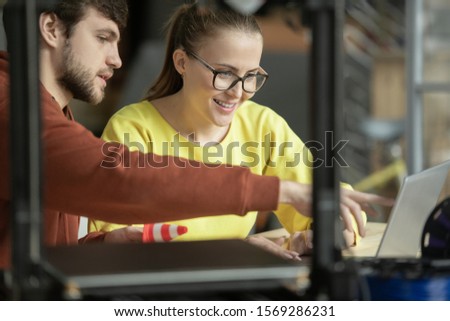 Zdjęcia stock: Young Confident Businessman Showing His Colleague Sketches Of New Items